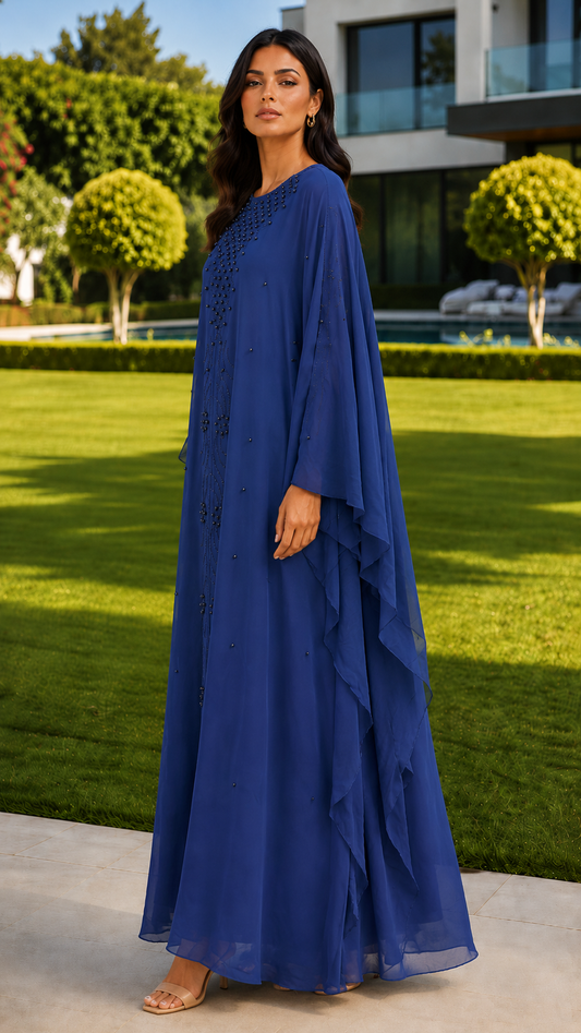 Royal blue beaded embroidered abaya for women by Rayyan & Co. with flowing cape sleeves and elegant modest design