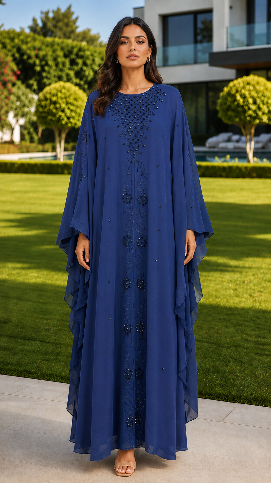 Royal blue beaded embroidered abaya for women by Rayyan & Co. with flowing cape sleeves and elegant modest design