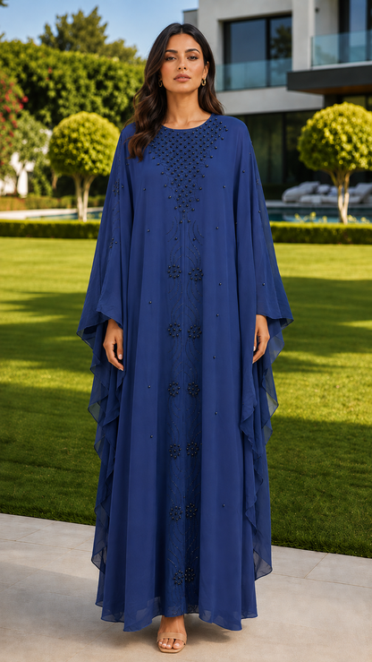Royal blue beaded embroidered abaya for women by Rayyan & Co. with flowing cape sleeves and elegant modest design